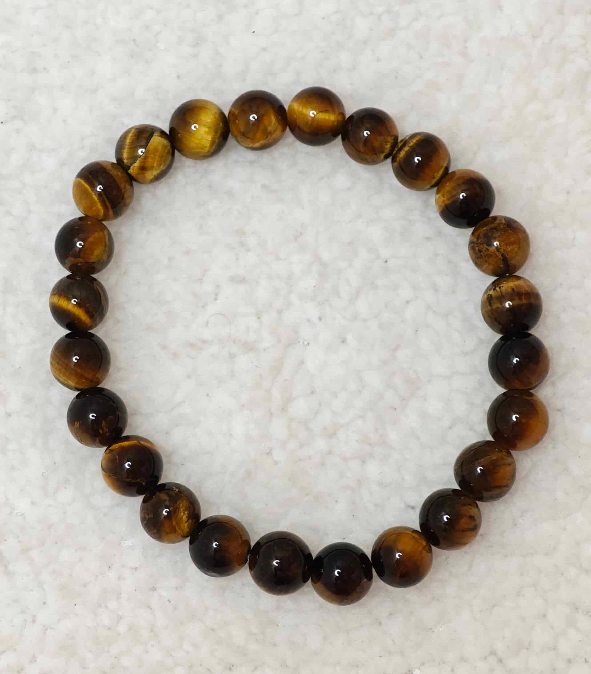Pierre : Oeil de tigre - Qualité : A - Origine : Afrique du Sud Taille de perle : 8mm - Forme : Boule Le produit que tu recevras peut différer de la photo de présentation, car chaque pierre naturelle est unique !